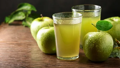 Fresh Green Apple Juice In Glasses With Whole Apples