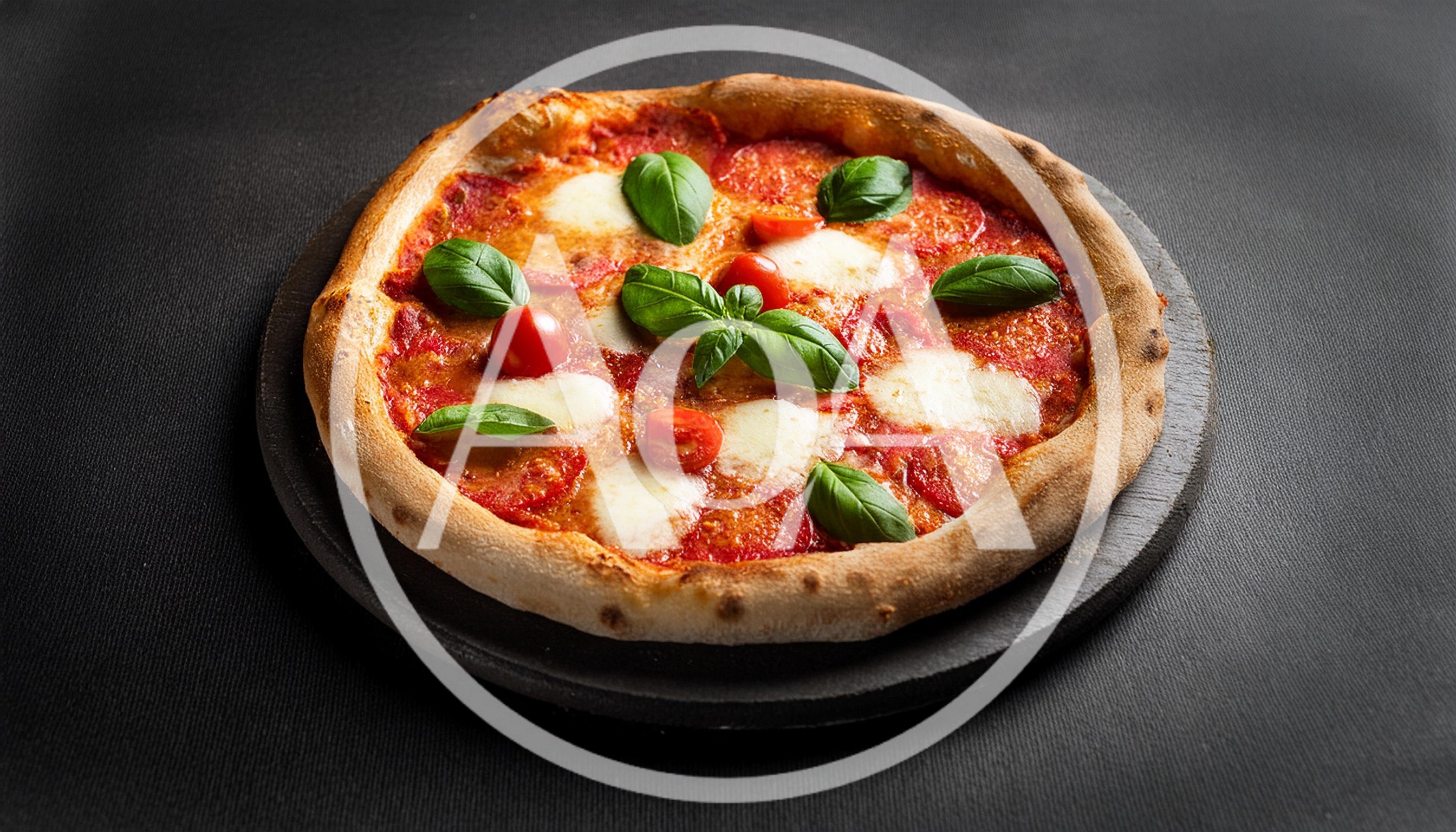 Fresh Margherita Pizza On A Dark Stone Board