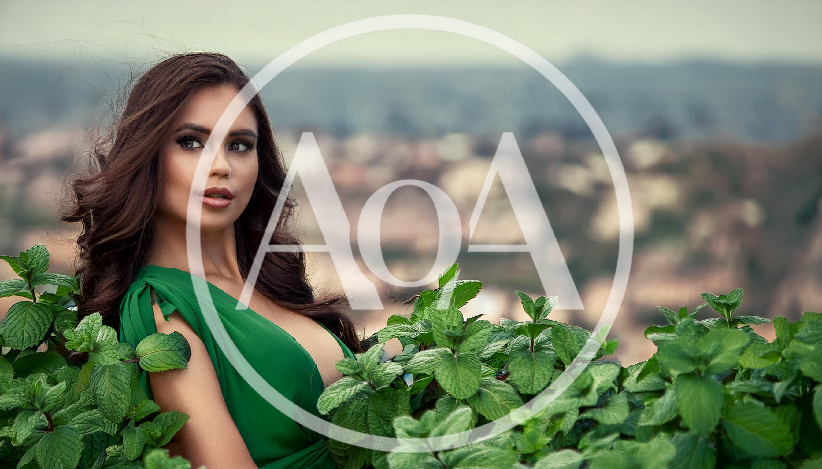 Beautiful Woman In Green Dress Posing With Mint Leaves