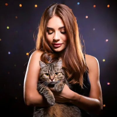 Young Woman Holding A Fluffy Tabby Cat