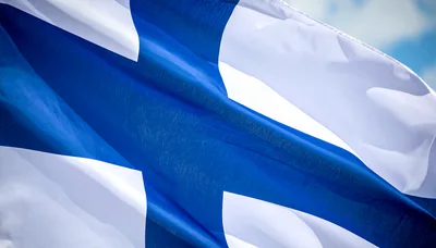 Waving Flag of Finland Against a Blue Sky