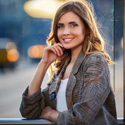 Young Woman Smiling Outdoors In City Setting