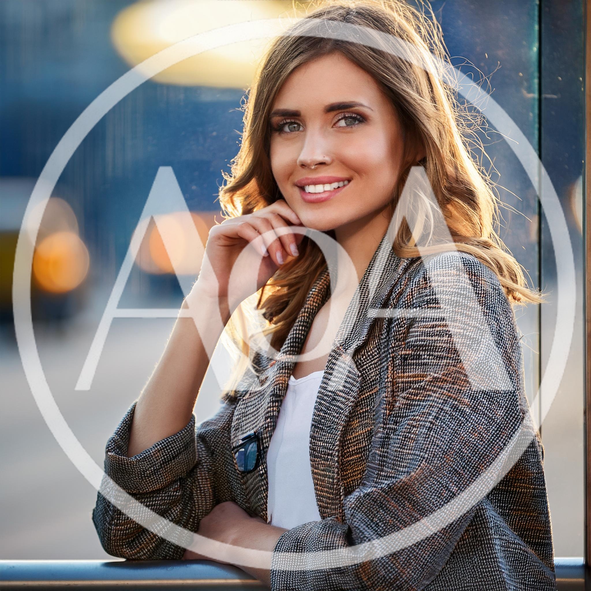 Young Woman Smiling Outdoors In City Setting