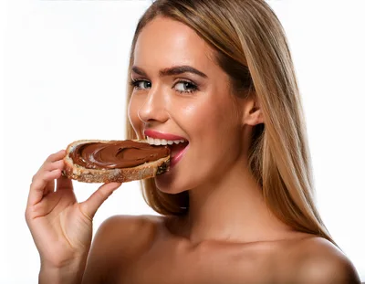 Beautiful Woman Eating A Slice Of Chocolate Spread Bread