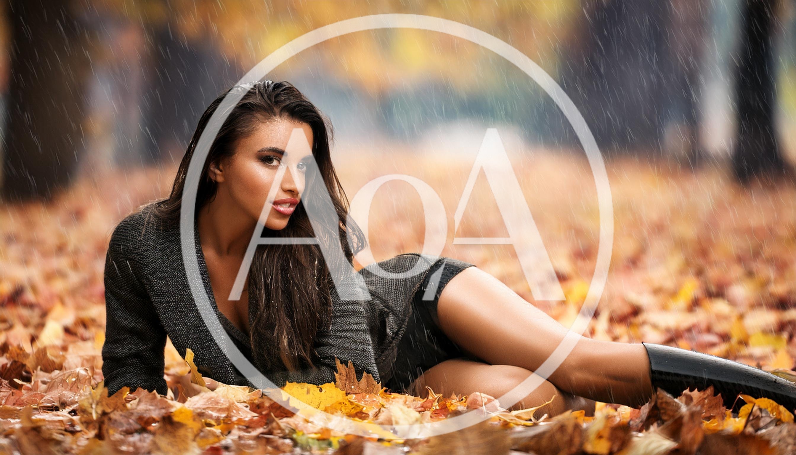 Beautiful Woman Lying In Autumn Leaves During Rain