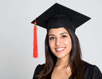 Smiling Female Graduate Wearing Academic Cap And Gown