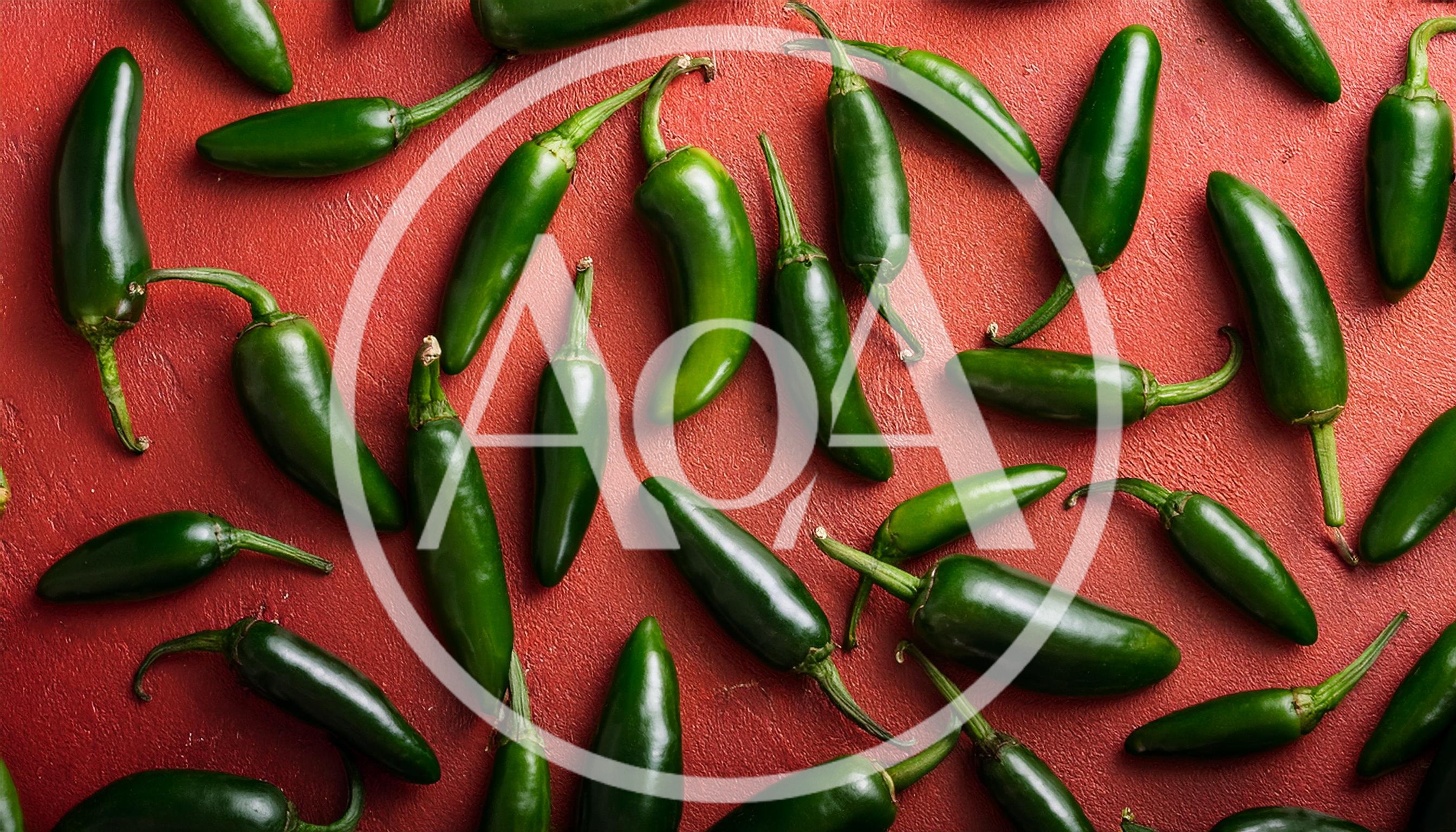 Fresh Green Jalapeno Peppers On Red Textured Background
