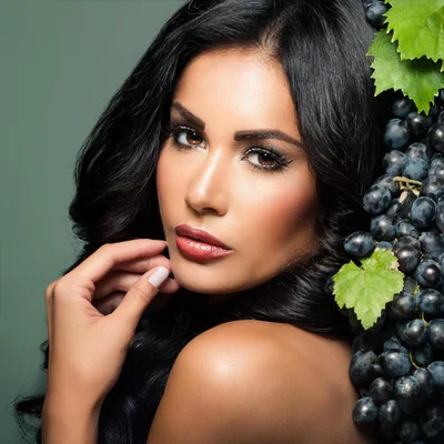 Beautiful Woman Posing With Fresh Dark Grapes