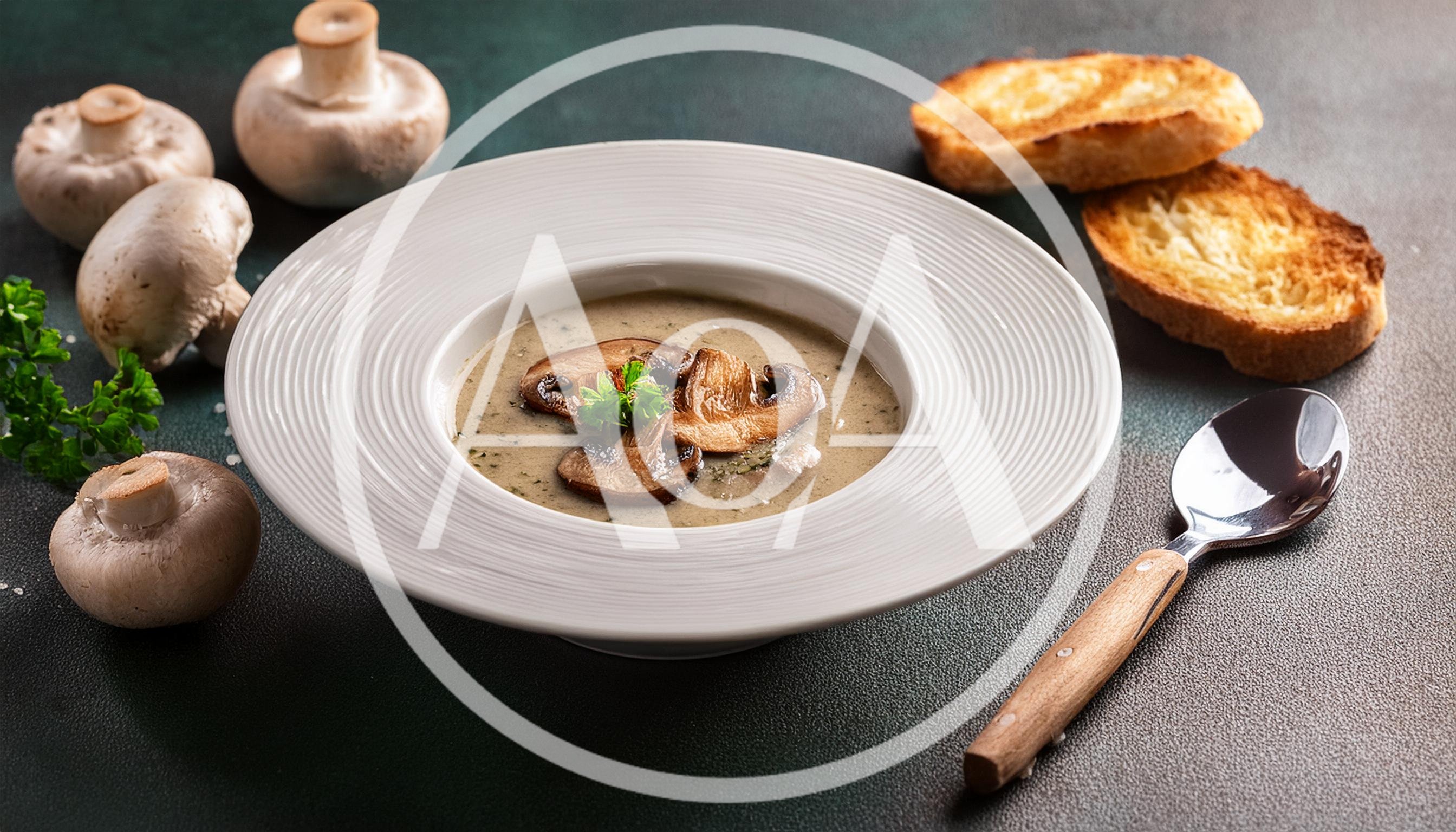 Creamy Mushroom Soup Served In A White Bowl