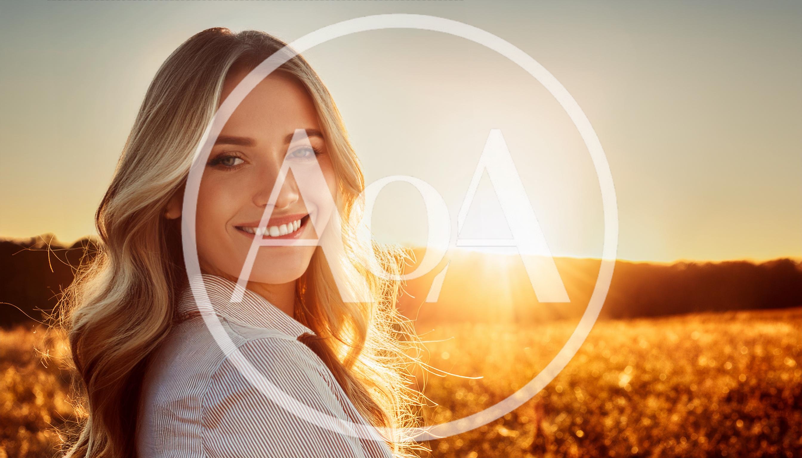 Smiling Blonde Woman Standing In A Golden Field