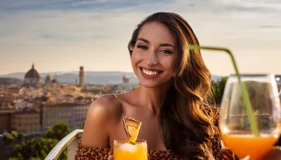 Smiling Woman Enjoying Cocktails Overlooking Florence Skyline