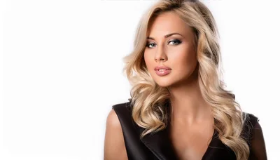 Portrait Of A Beautiful Blonde Woman In Leather Vest