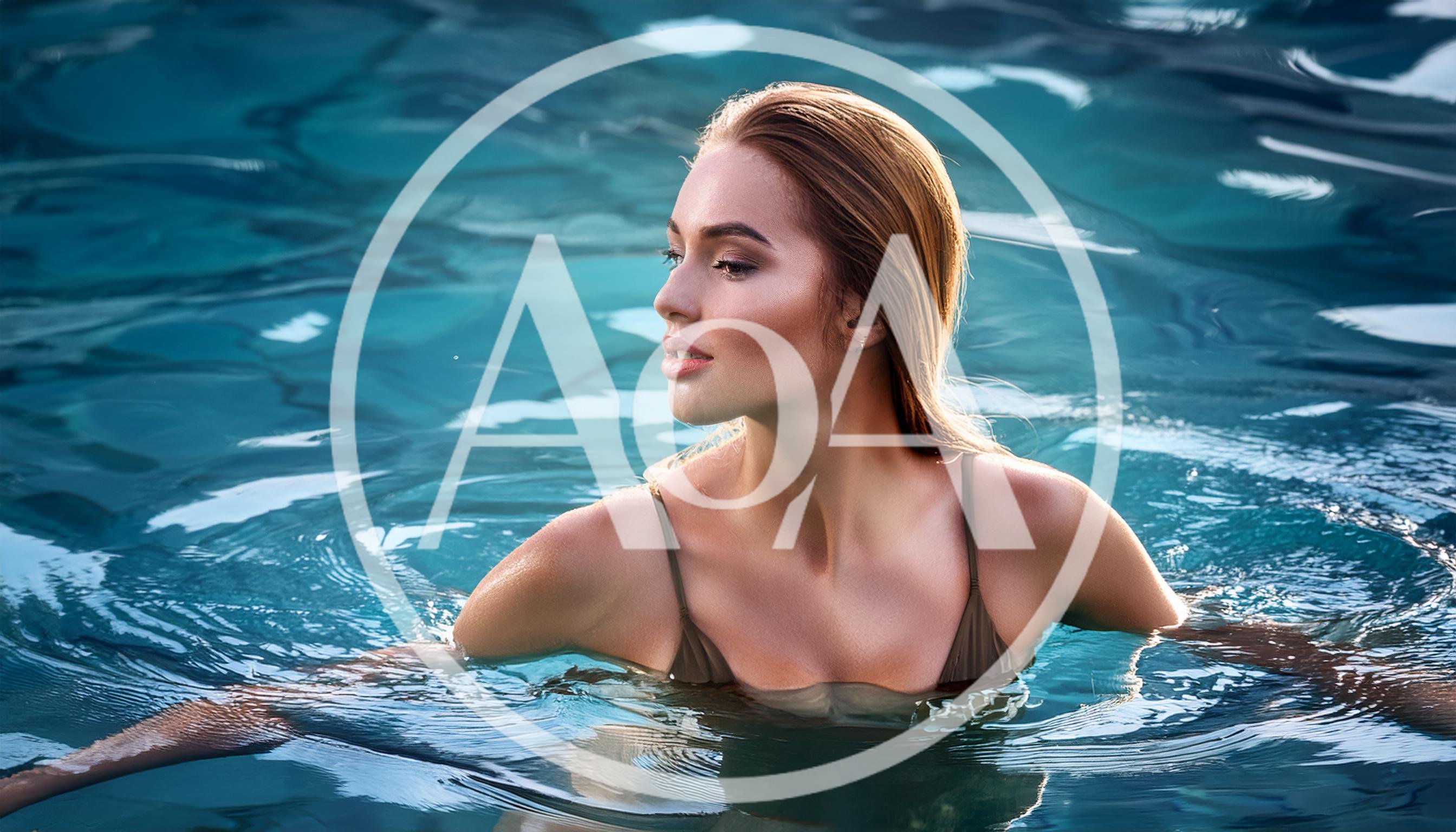 Young Woman Swimming In A Luxury Hotel Pool