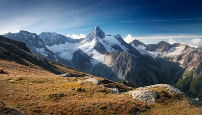 Majestic Alpine Mountain Peak With Glaciers And Rocky Terrain