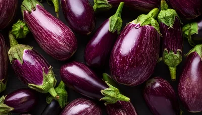 Fresh Purple Striped Eggplants On Dark Wooden Background