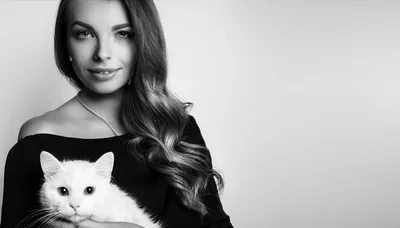 Elegant Woman Holding A Fluffy White Cat