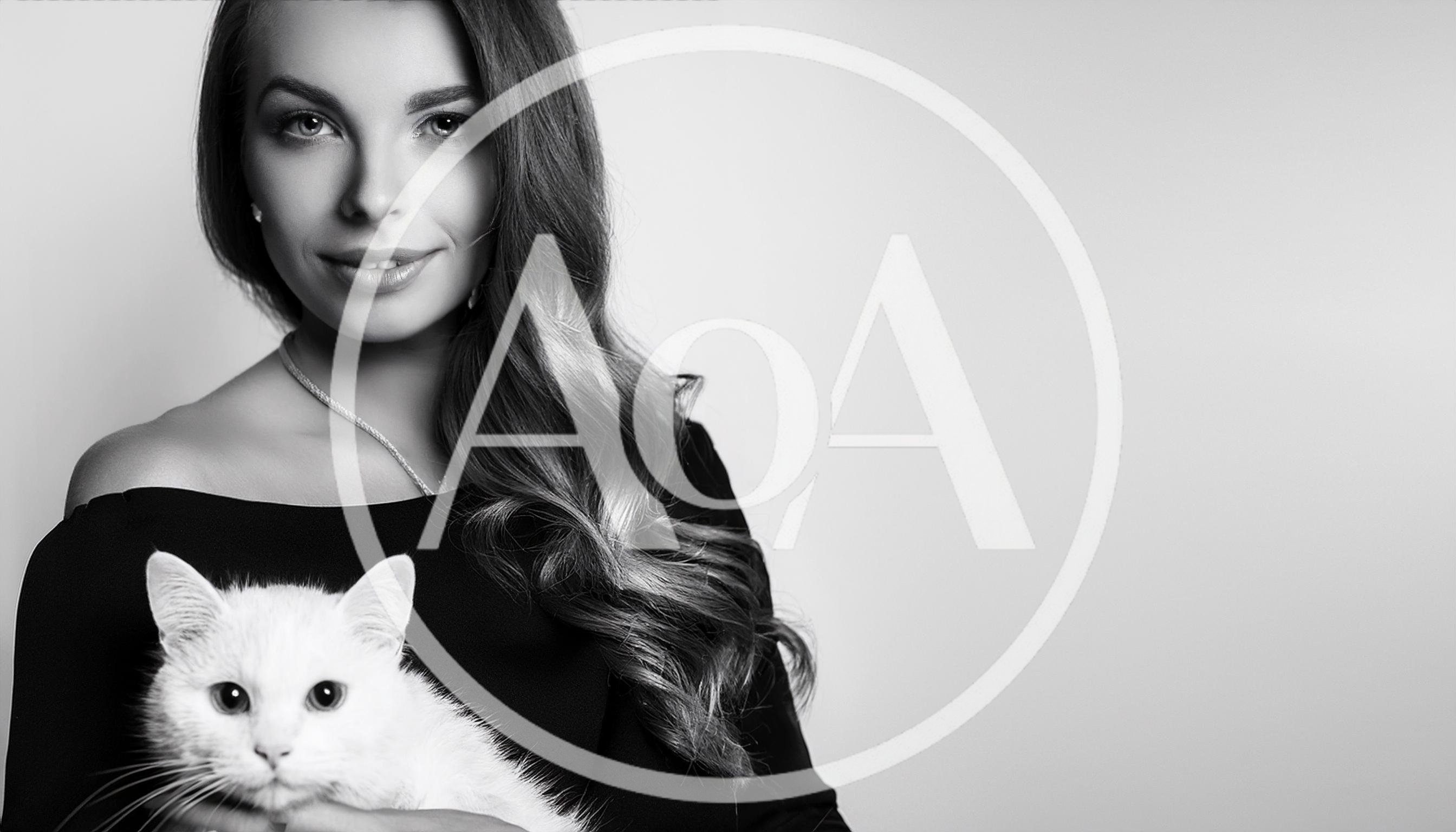 Elegant Woman Holding A Fluffy White Cat