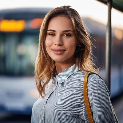 Young Woman Waiting At A Public Transit Stop
