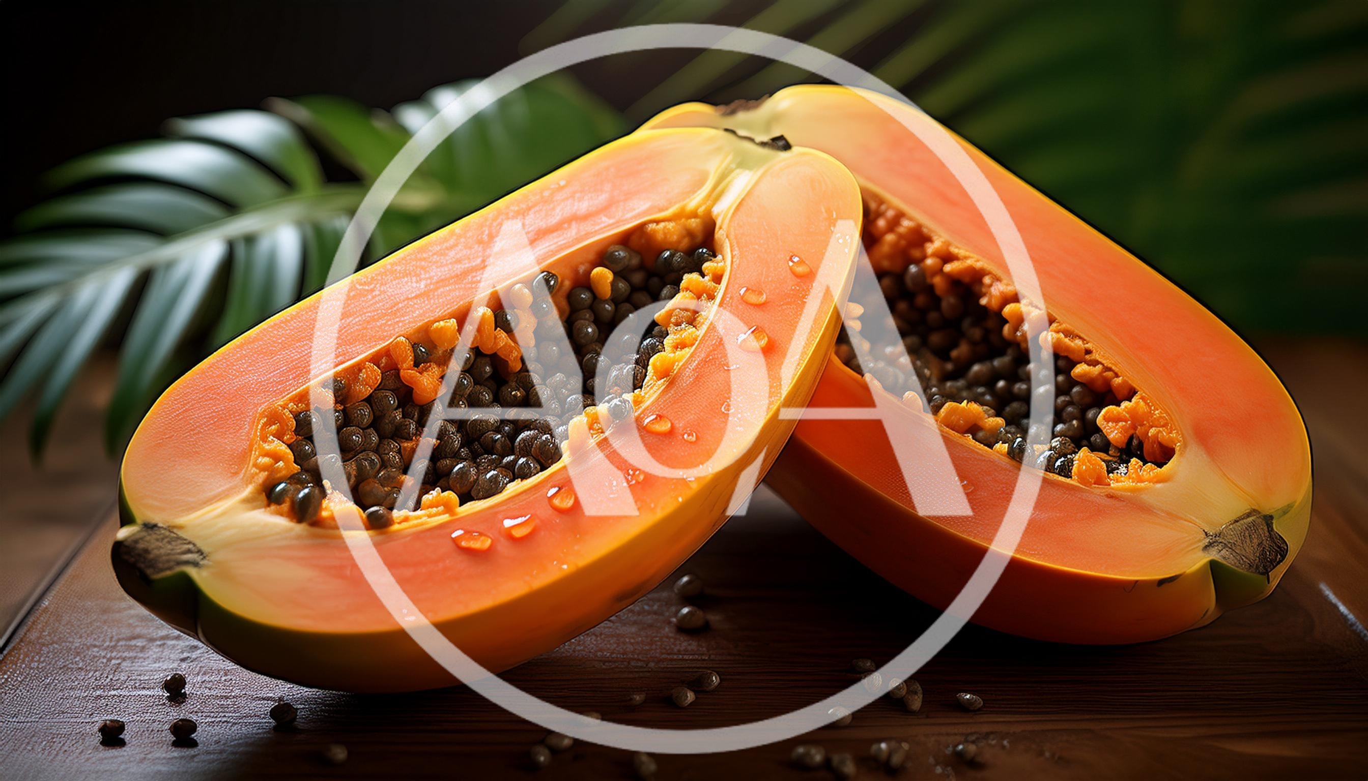 Two Halves Of A Ripe Papaya On A Wooden Table