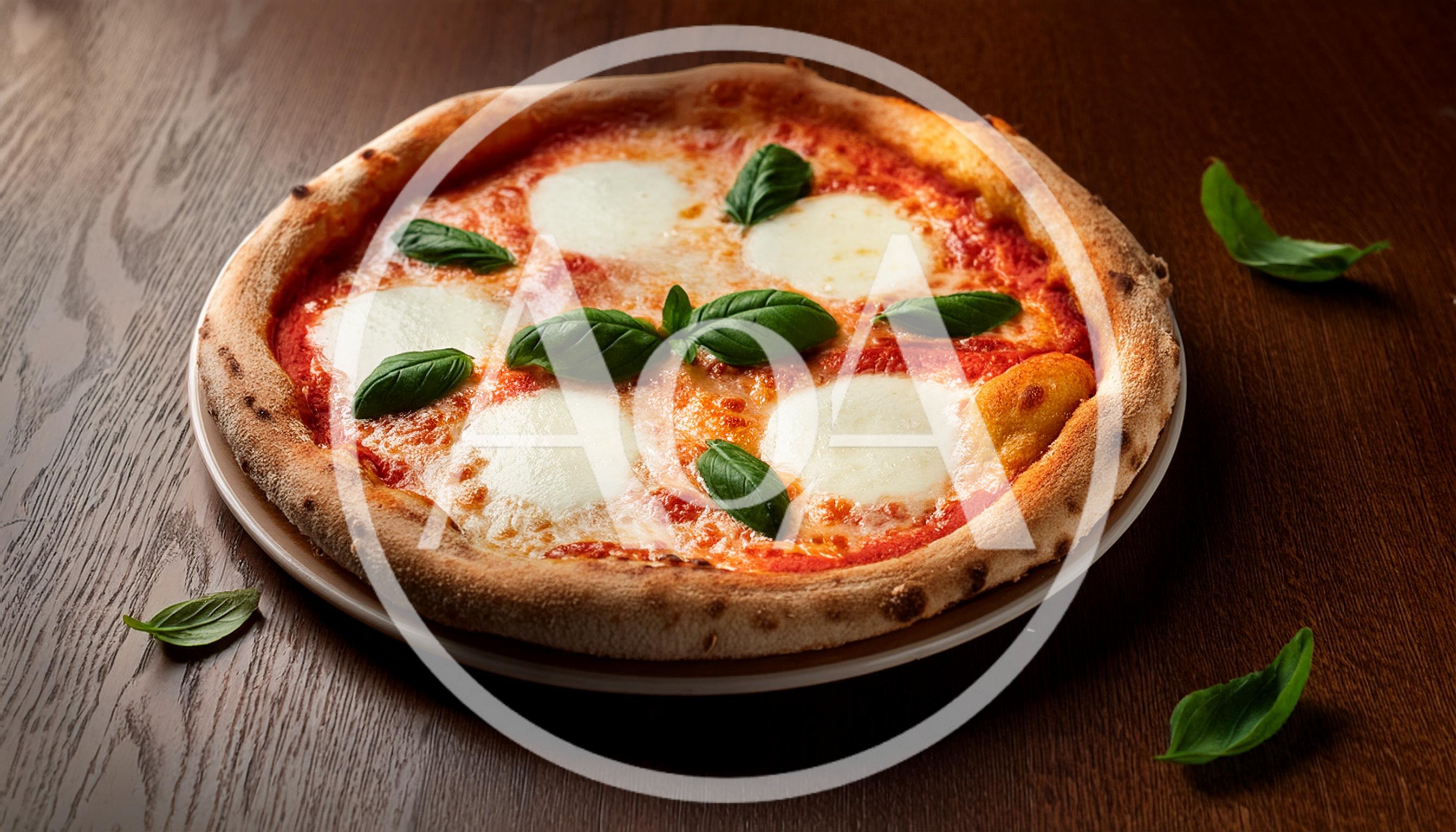 Fresh Margherita Pizza With Basil Leaves On Wooden Table