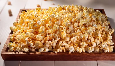 Freshly Popped Popcorn In A Wooden Tray