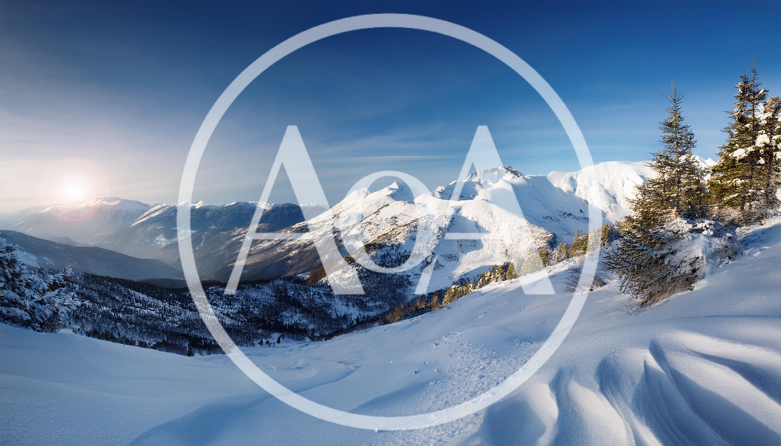 Panoramic View Of Snowy Mountain Peaks At Sunrise