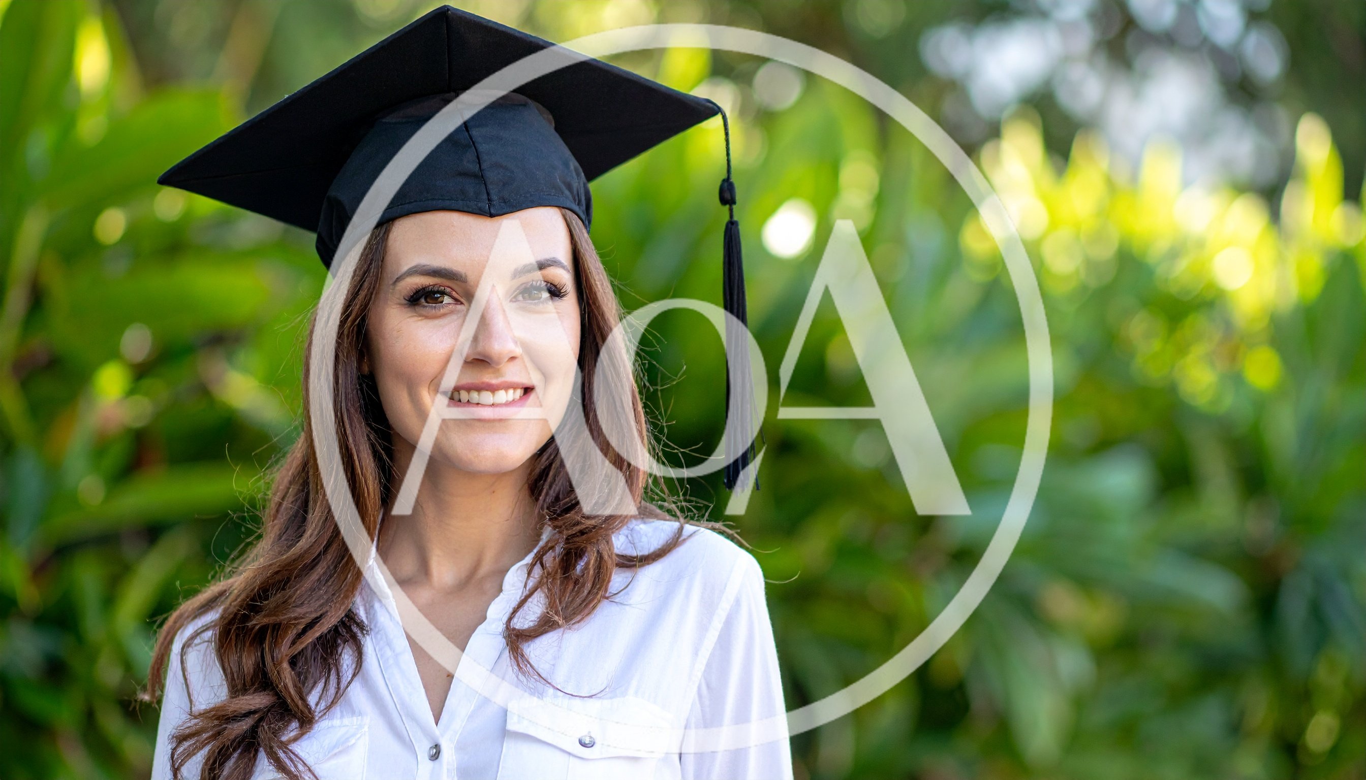 Smiling Female Graduate Wearing Academic Cap Outdoors