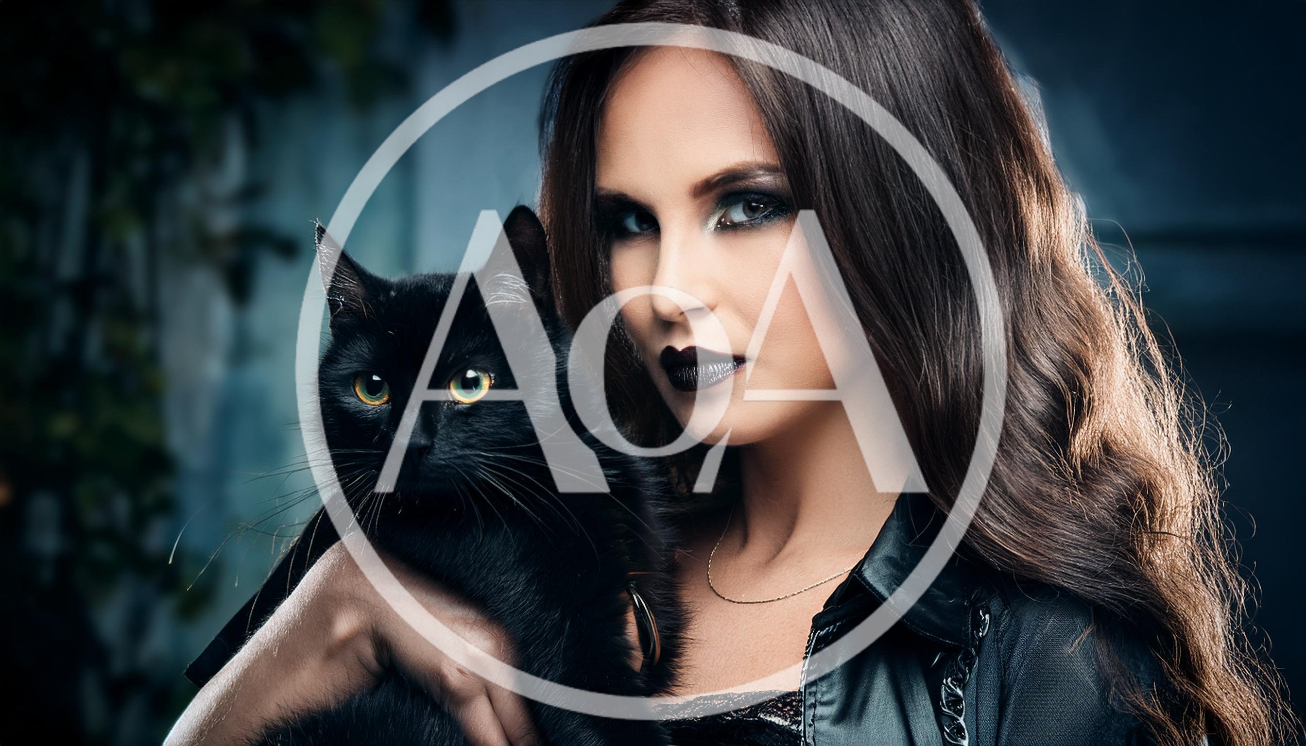 Woman With Dark Makeup Holding A Black Cat
