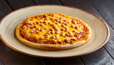 Baked Bean Pizza On A Rustic Ceramic Plate