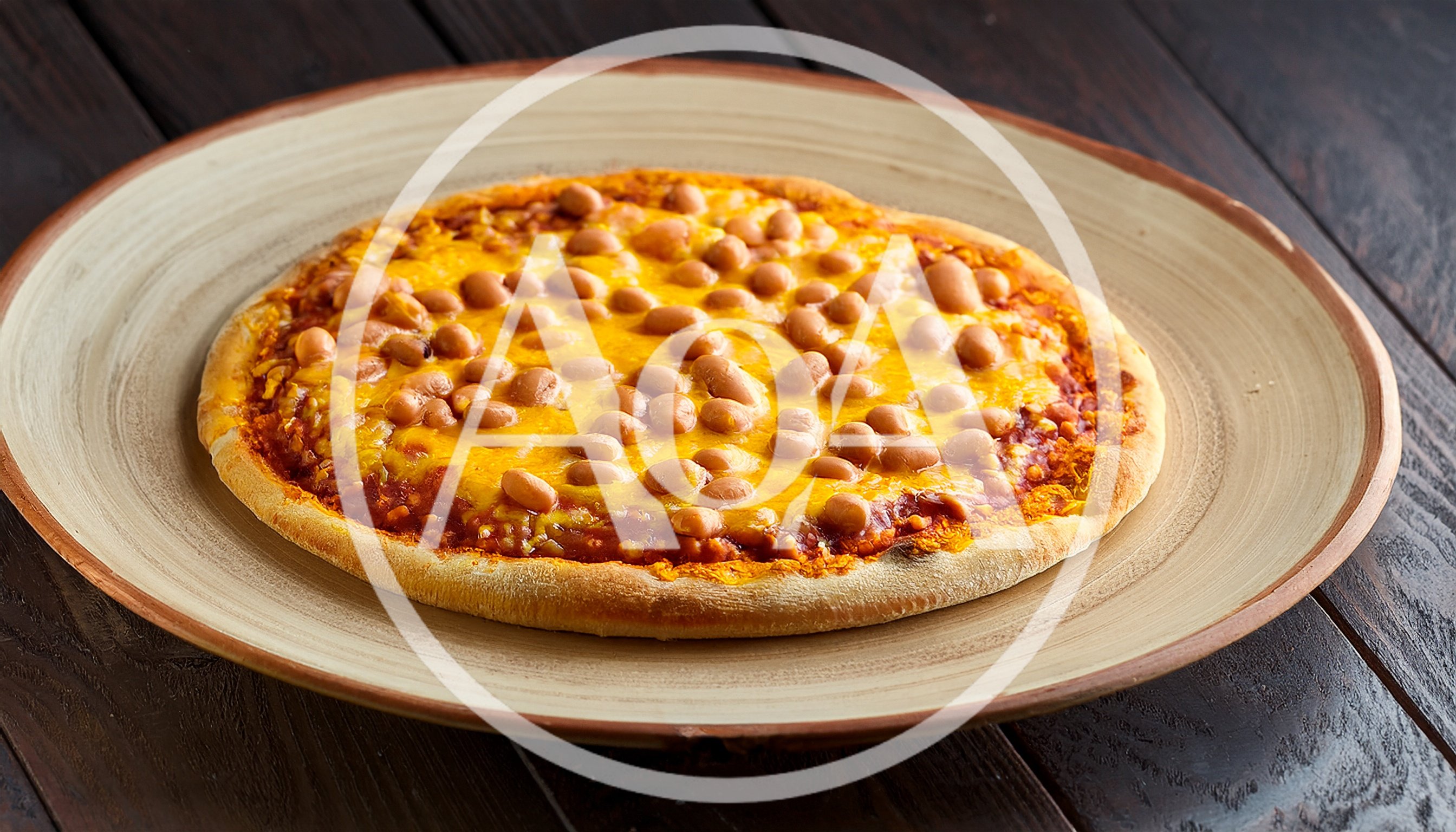 Baked Bean Pizza On A Rustic Ceramic Plate