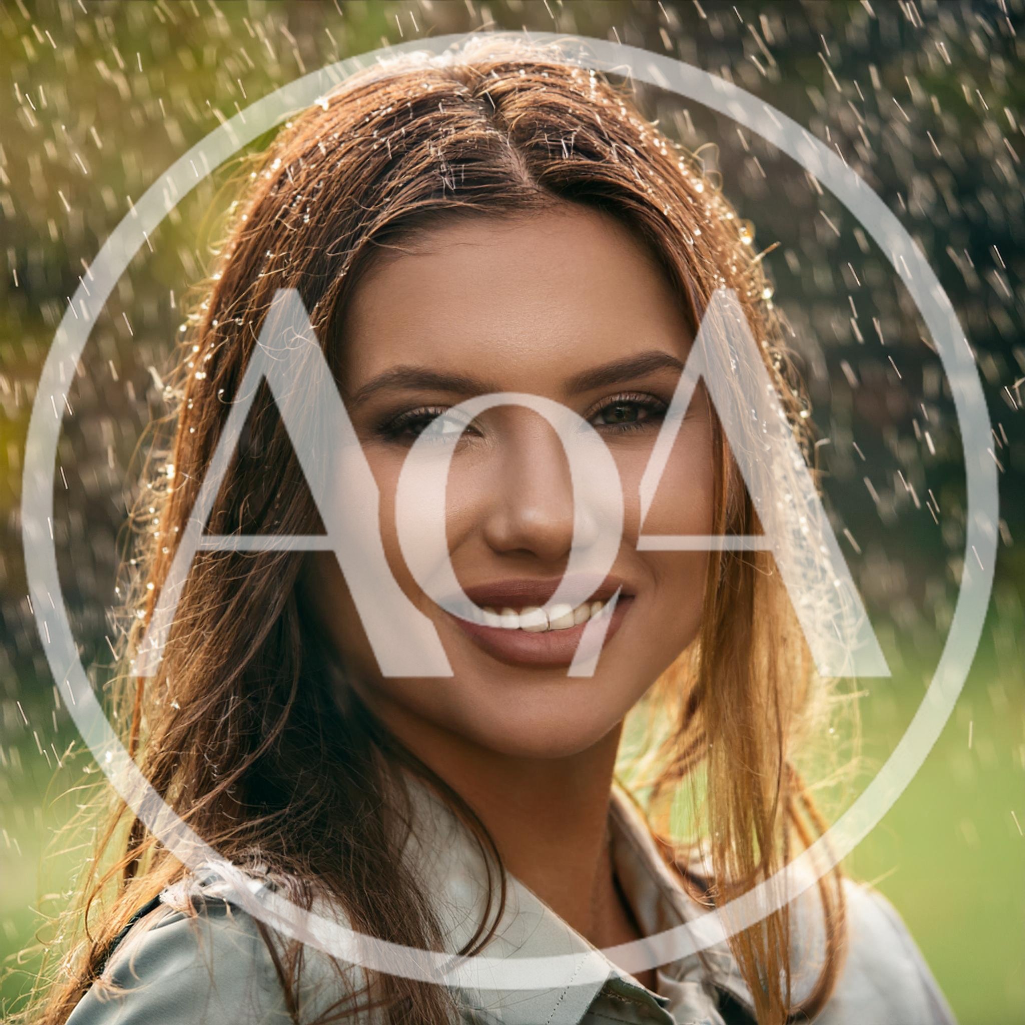 Portrait of a Smiling Woman Standing in Rain