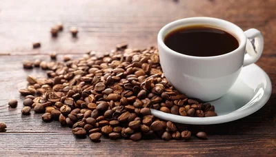White Cup Of Black Coffee With Roasted Coffee Beans
