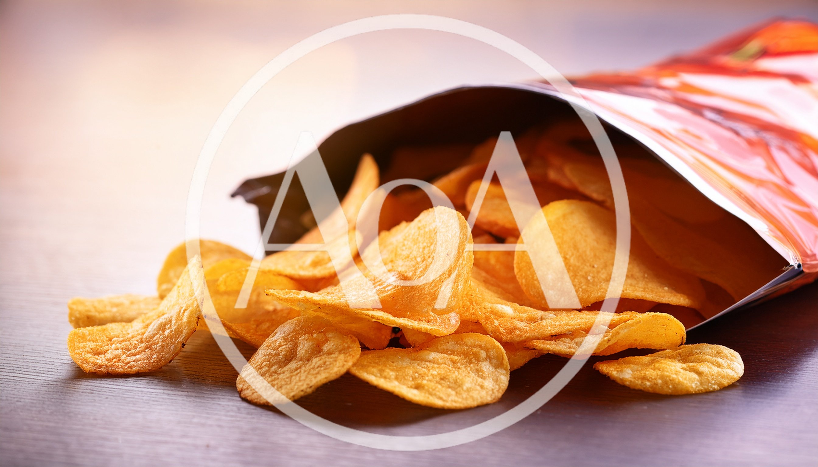 Potato Chips Spilling From An Open Snack Bag