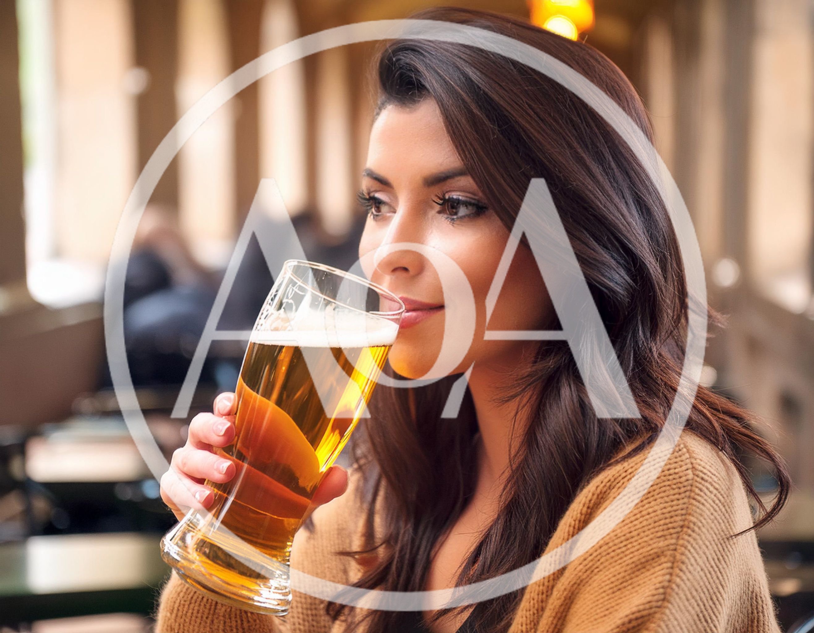 Young Woman Drinking Beer at an Outdoor Cafe