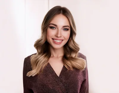 Portrait Of A Smiling Young Woman With Wavy Hair