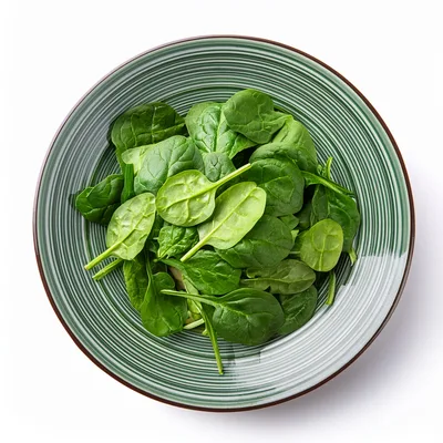 Fresh Green Spinach Leaves In A Striped Bowl