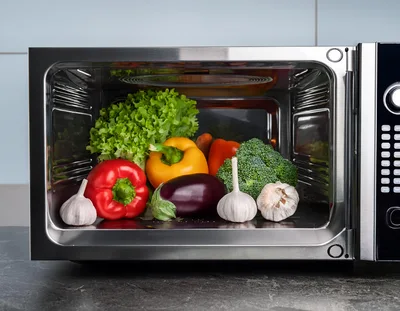 Fresh Vegetables Inside A Stainless Steel Microwave Oven