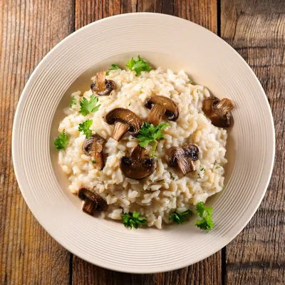 Creamy Mushroom Risotto Served In A White Bowl