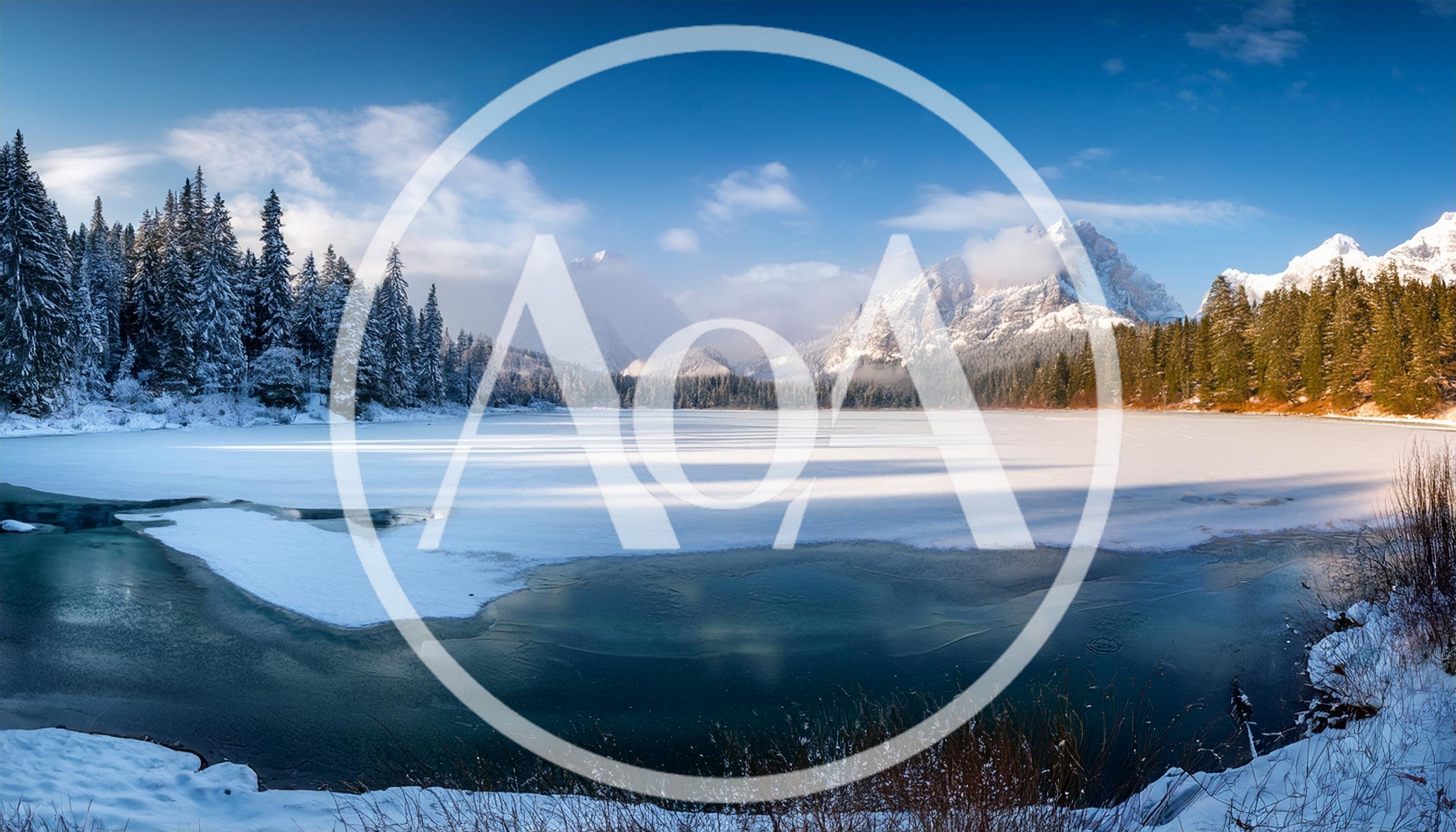 Panoramic View Of Frozen Lake And Snowy Mountains