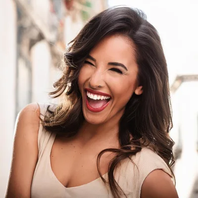 Joyful Woman Laughing Outdoors With A Radiant Smile