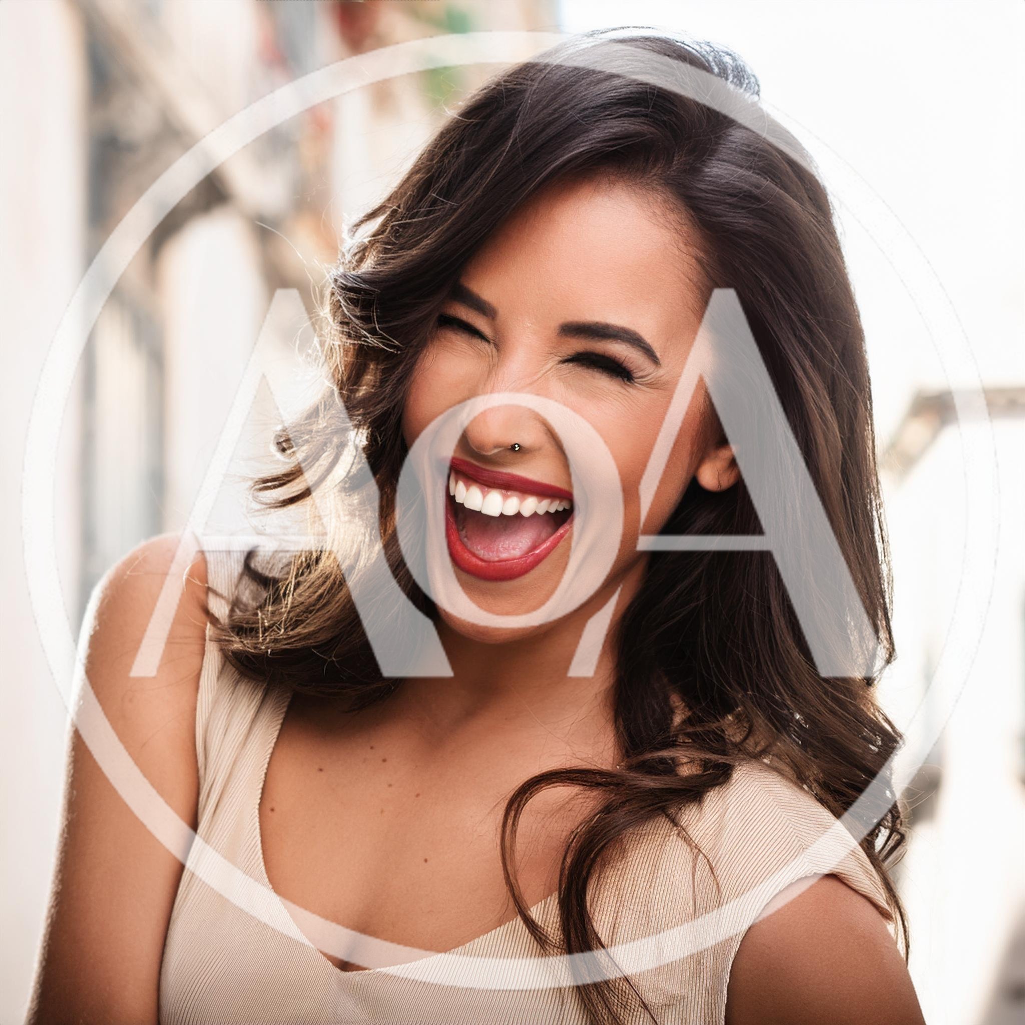 Joyful Woman Laughing Outdoors With A Radiant Smile