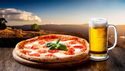 Pizza And Beer On A Wooden Table At Sunset