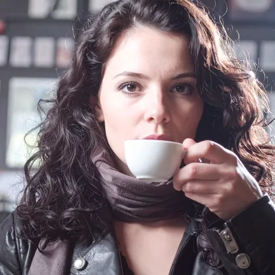 Young Woman Drinking Coffee In A Cafe