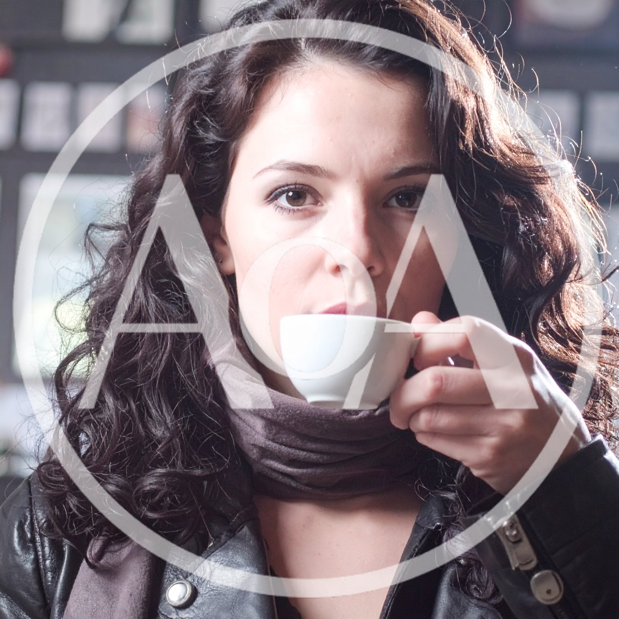 Young Woman Drinking Coffee In A Cafe