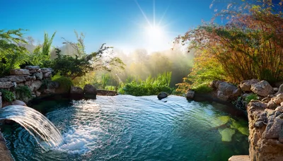 Natural Stone Waterfall Pool In A Lush Garden