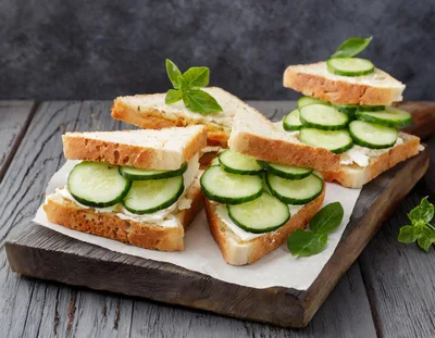 Fresh Cucumber Sandwiches On A Wooden Cutting Board