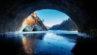 Frozen River View From Inside A Natural Ice Cave