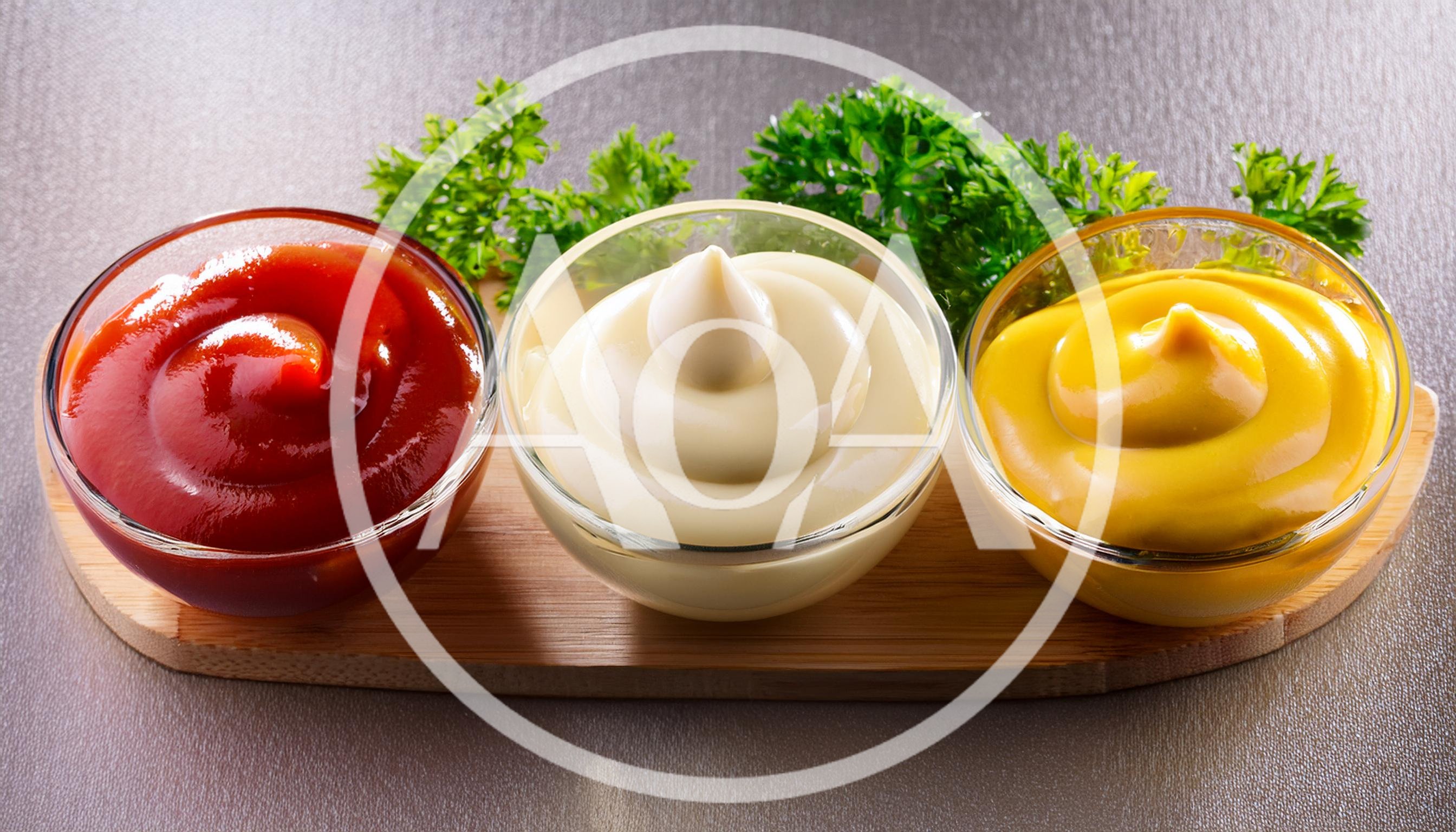 Three Glass Bowls With Ketchup Mayonnaise And Mustard