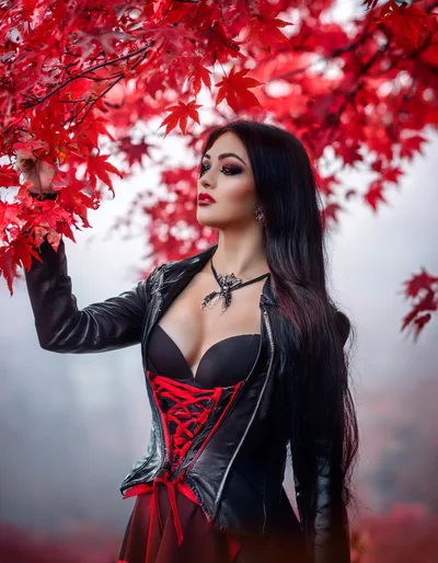 Gothic Woman Posing Under Vibrant Red Maple Leaves