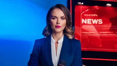 Professional Female News Anchor Presenting In Studio